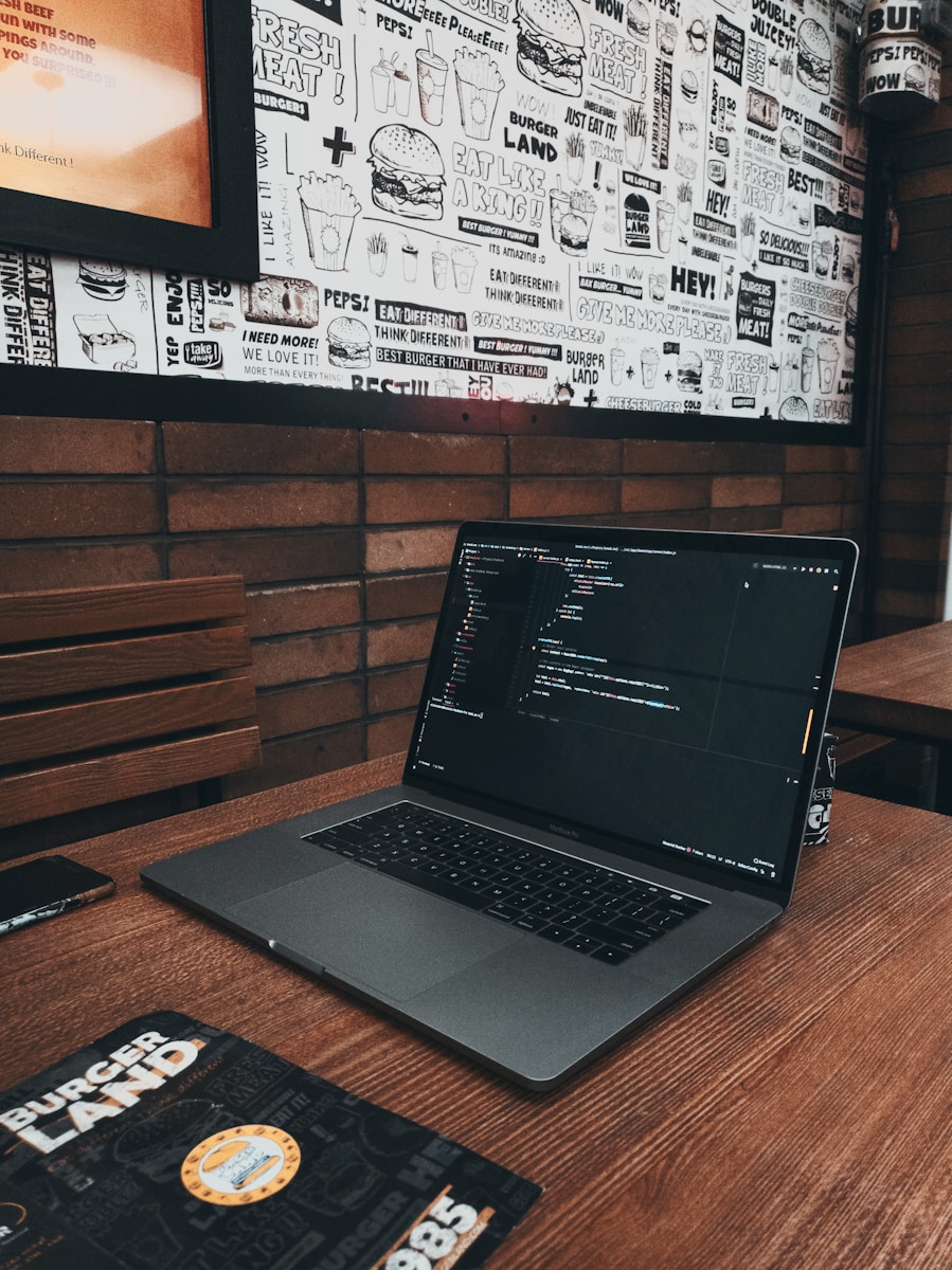 MacBook Pro on brown wooden table